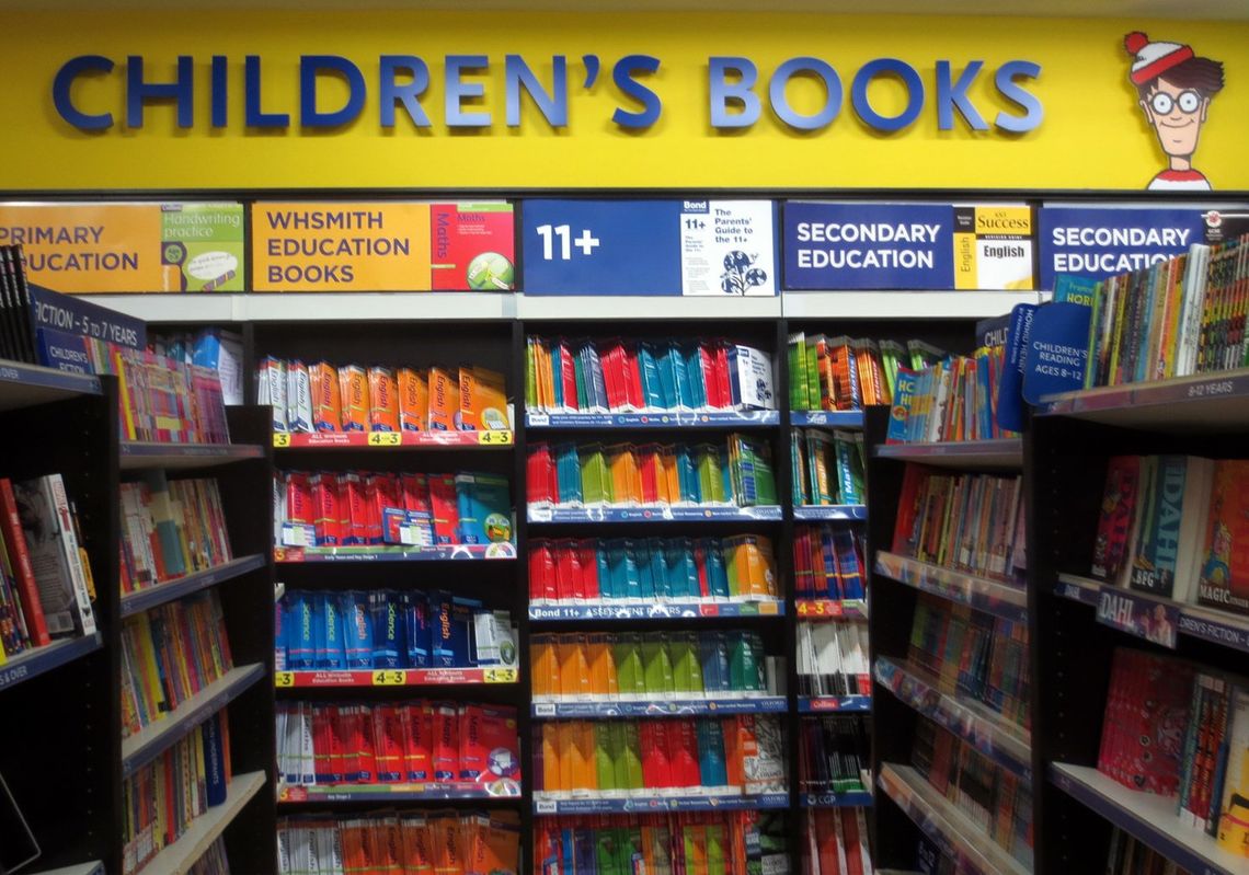 Packed high street shelves of primary, 11+ and secondary education workbooks